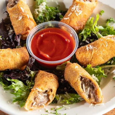 Philly Cheesesteak Egg Rolls, with spicy ketchup.