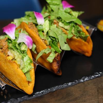 Venezuelan empanadas, filled with guacamole, passion fruit pico de gallo, and lettuce.