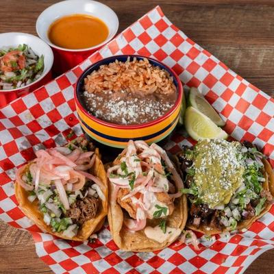 3 street tacos with lime wedge, beans, rice, salsa and pico.