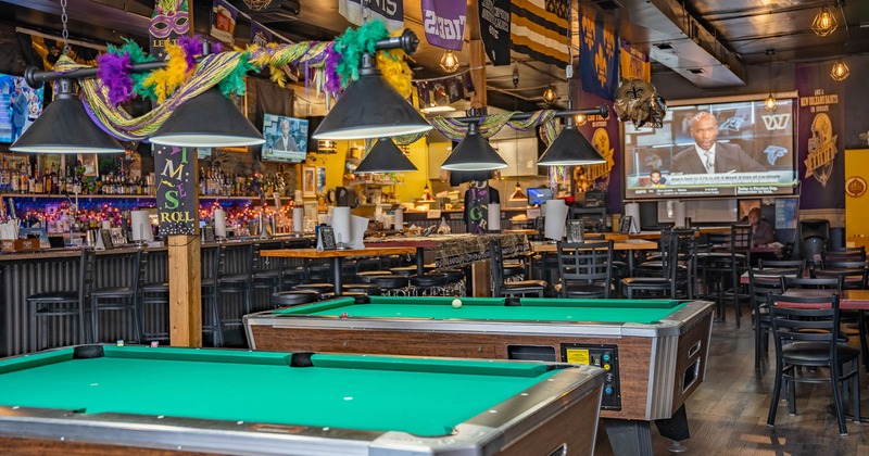 Interior, pool tables with seating area behind