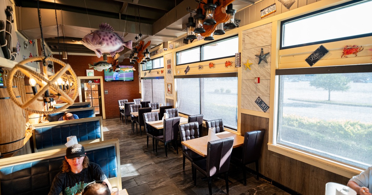 Interior, sea themed dining area with leather sofas and chairs