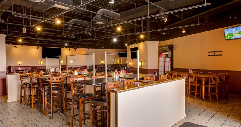 Interior, high tables and chairs, tv screens on the walls