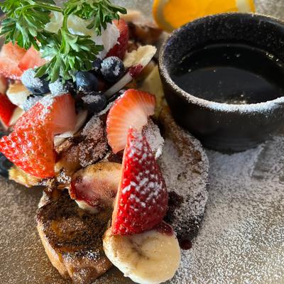 French toast  topped with fresh berries, bananas, cinnamon, and berries sauce.