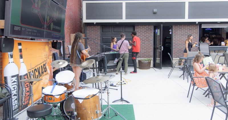 A band performs in an outdoor patio area