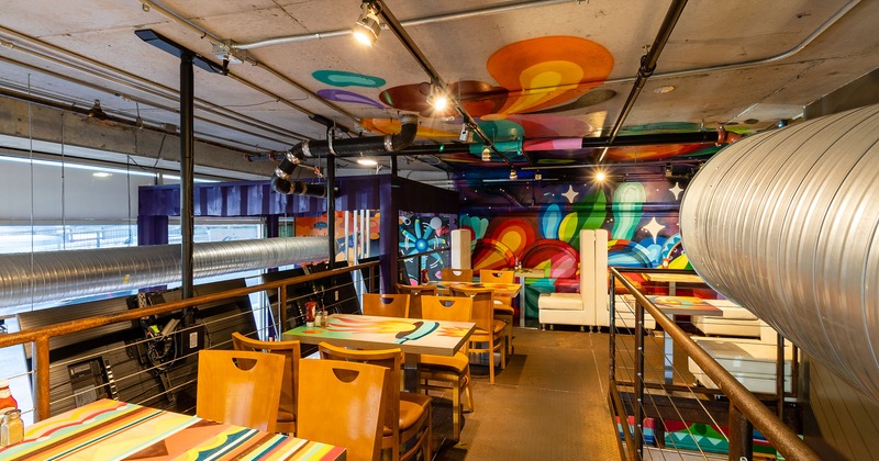 Interior, colorful dining area, tables and booths