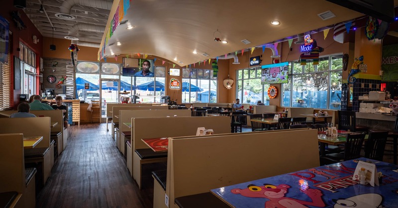 Interior, dining area with few customers seating  at the tables