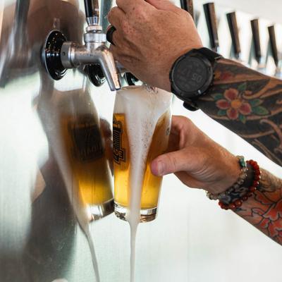 Hands pouring beer.