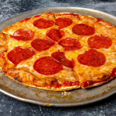 A pepperoni pizza on a metal tray.