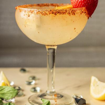 Pineapple Jalapeno Margarita with strawberry garnish and spicy rim.