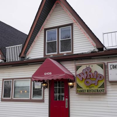 Restaurant's entrance with a sign.