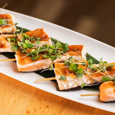 Salmon skewers topped with micro greens.