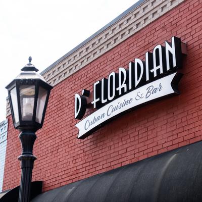 The restaurant's sign on the exterior wall of the building.