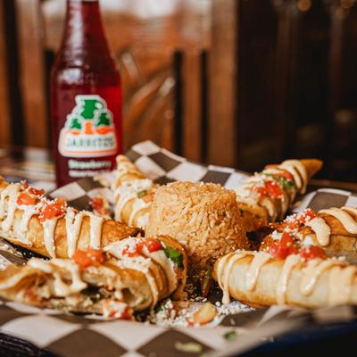 Taquitos with crema, rice, pico de gallo, and Jarritos soda.
