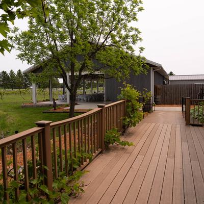 The Barrel Room deck overlooking the vineyard and wedding pavilion at Next Chapter Winery.
