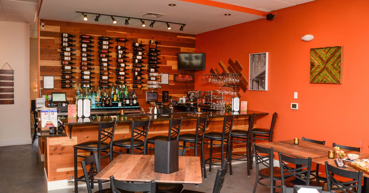 Interior, tables and chairs, bar and bar stools in the back