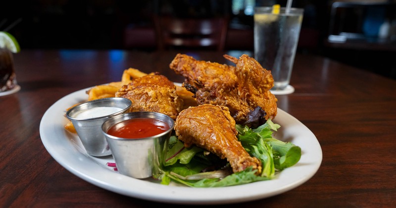 Broasted chicken served with fries and dipping sauces