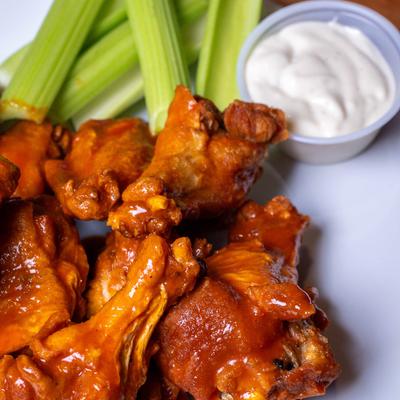 Chicken Wings with celery and a sauce.