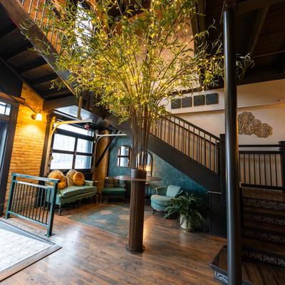Interior, lobby seating with a decorative tree.