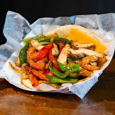 Stir Fry Chicken Dinner with juicy chicken, colorful veggies, and a choice of sauce.