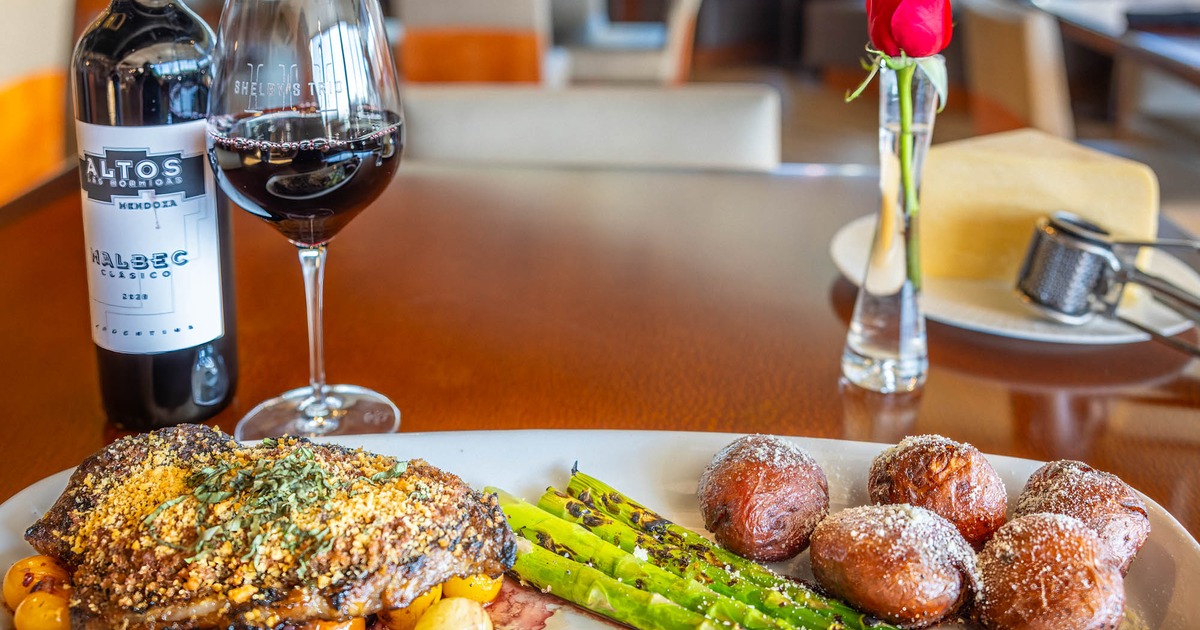 Steak Palermo plate arranged with a glass and a bottle of red wine