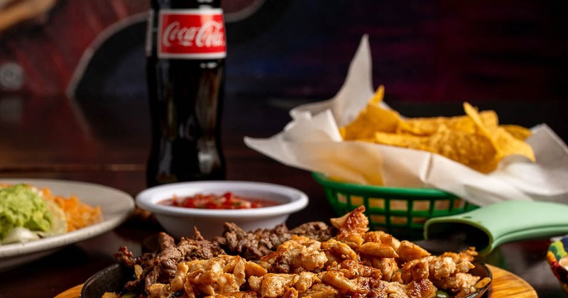 Steak and chicken fajitas serves with various sides and soft drink