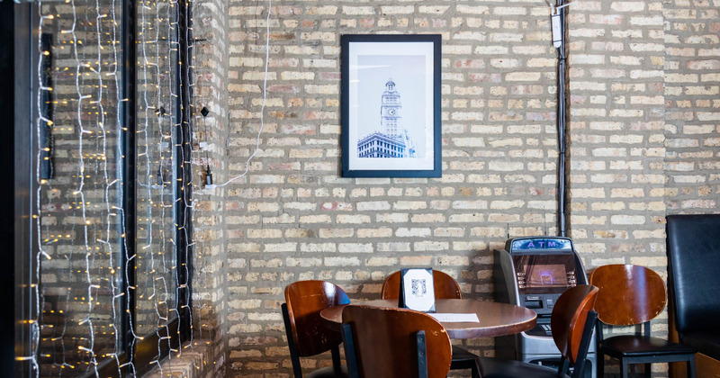 Table in the corner and ATM machine inside the restaurant