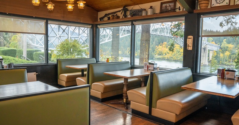 Interior space, dining area, upholstered dining booths lined up by the windows