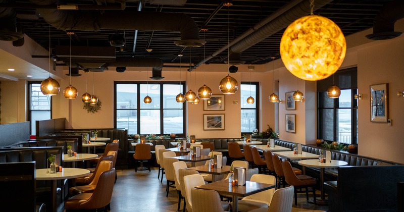 Seating area with tables in the middle and booths on the sides