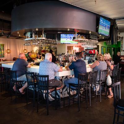 Customers sitting at the bar.