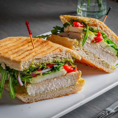 Grilled Chicken Pesto sandwich on a white plate.