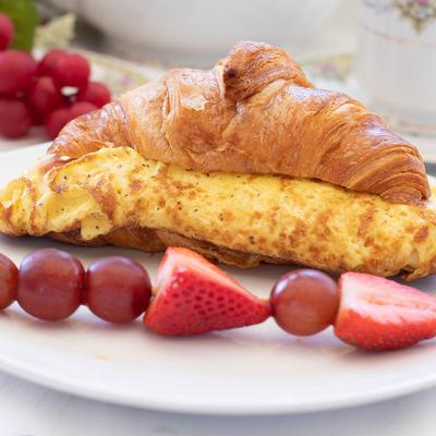 Egg, Ham and Cheese Croissant, served with fruit