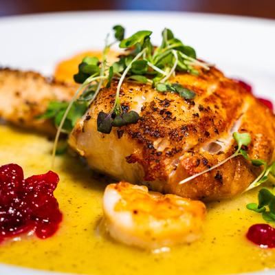 Pan-seared fish dish garnished with microgreens.