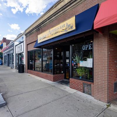 Orchid 7 Fusion Bar and Grill storefront with signage and navy blue awning.