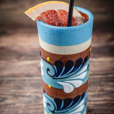 Paloma cocktail garnished with a grapefruit slice.