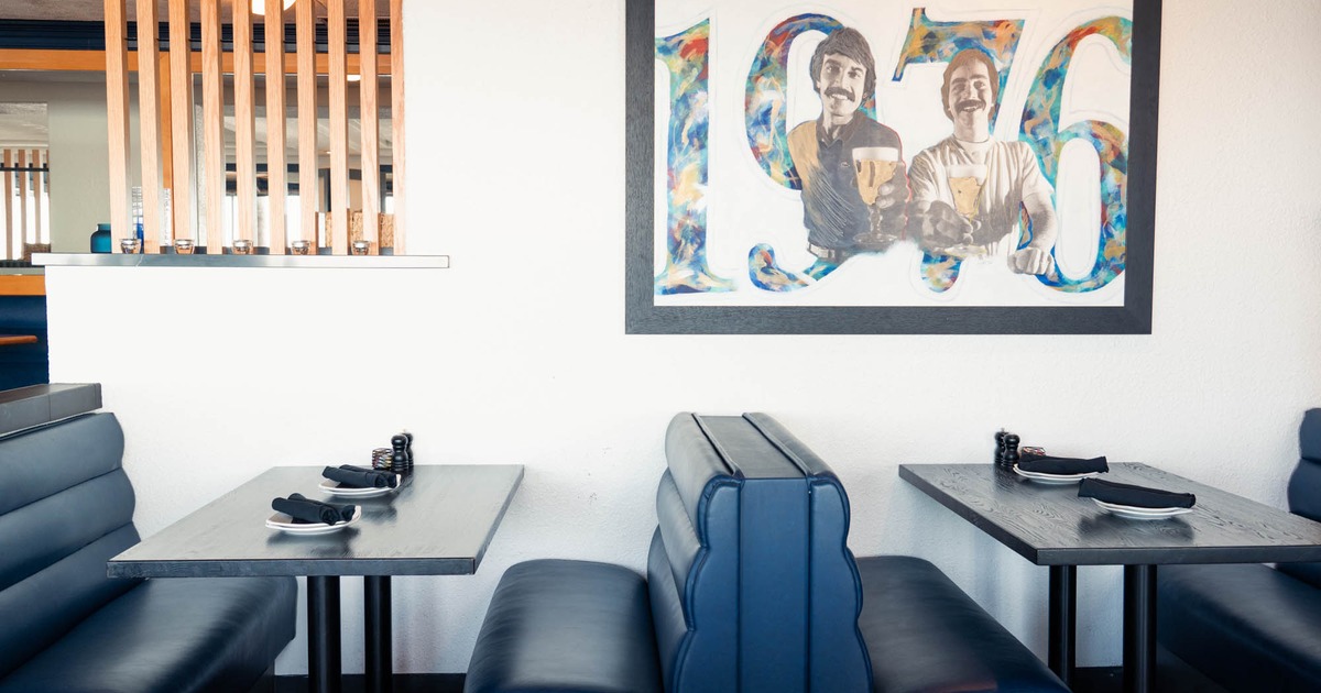 Interior, tables with tableware and leather benches