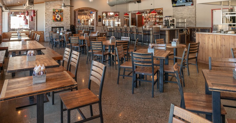 Interior, seating area, wooden top tables with wooden chairs, ready for guests