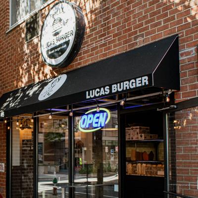Storefront with brick facade and a business sign.