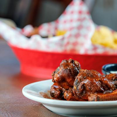 Buffalo wings served on the table with other menu items.