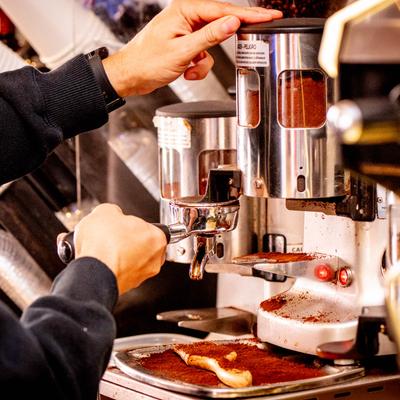 A barista operating a coffee machine.