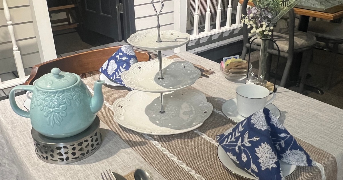 Tea service table with teapot and tiered stand