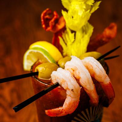 Bloody Mary with shrimp and bacon garnish.