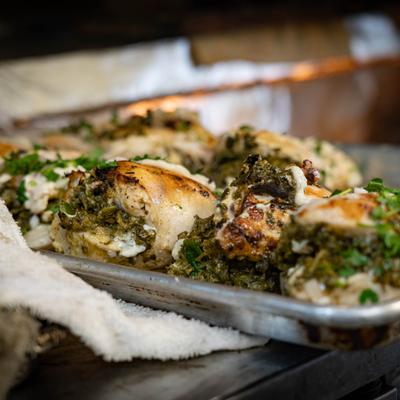 Herb roasted chicken pieces on a metal tray.