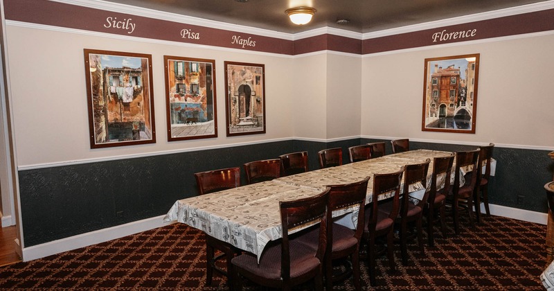 Interior, long table with Italian posters on the wall