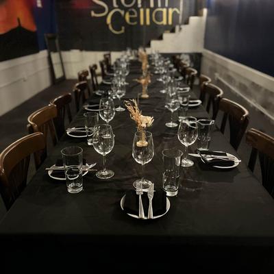 Storm Cellar event table with black tablecloth and place setting.