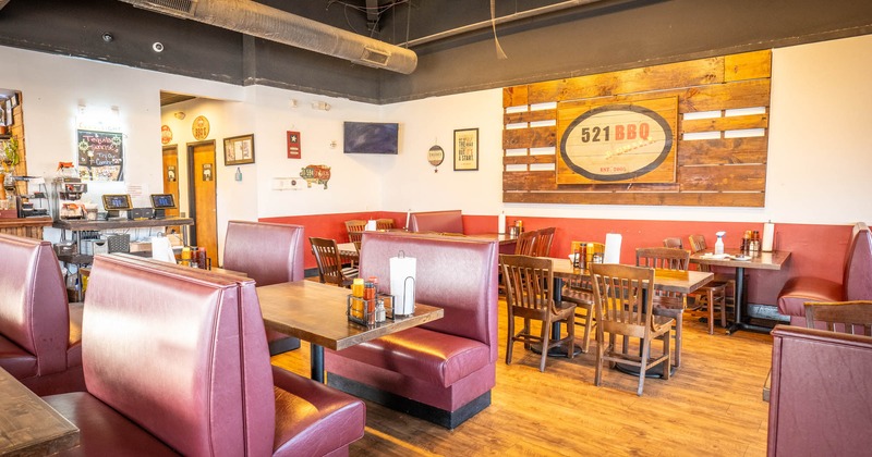 Interior, leather booths,  wooden tables and chairs in the back