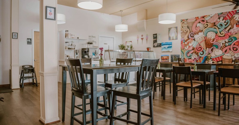 Interior, dining area, high and regular tables with chairs, prep station in the back