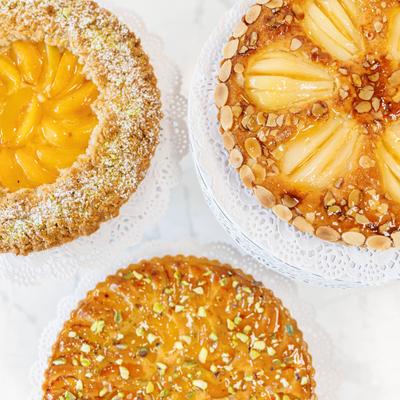 Peach tart, pear and almond tart, and apricot pistachio tart.