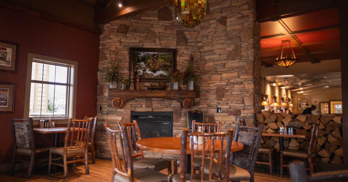 Interior, tables and chairs near fireplace