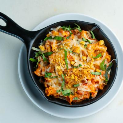 Pasta in marinara sauce, topped with melted cheese, fresh basil leaves & crumbled breadcrumbs.