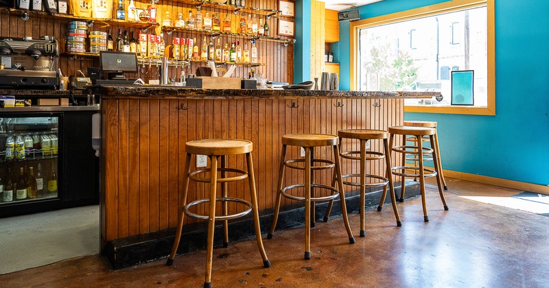 Interior, bar, drink rack behind, stools in front